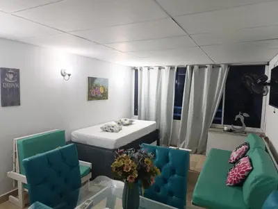 a room with a table and two chairs and a table and a room with at Excelente vista al mar in Cartagena de Indias