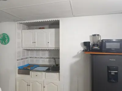 a kitchen with white cabinets and a sink and a microwave at Excelente vista al mar in Cartagena de Indias
