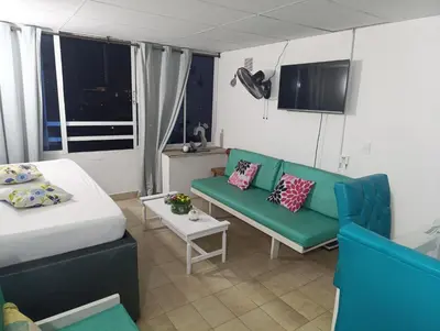 a room with a bed and a couch and a table at Excelente vista al mar in Cartagena de Indias