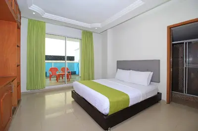 a bedroom with a bed and a large window at Hotel Abi Inn By GEH Suites in Cartagena de Indias