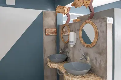 a bathroom with two sinks and a mirror at La Playita Isla Fuerte in Isla Fuerte