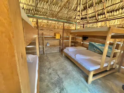 a bedroom with bunk beds in a straw hut at La Playita Isla Fuerte in Isla Fuerte