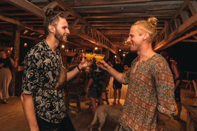 a man and a woman holding glasses of wine at La Playita Isla Fuerte in Isla Fuerte