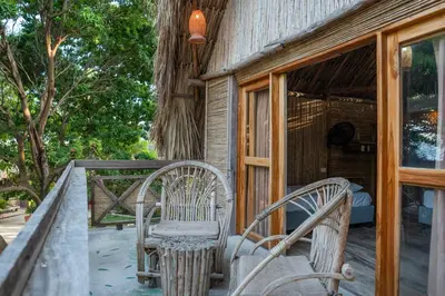 two chairs sitting on the porch of a house at La Playita Isla Fuerte in Isla Fuerte