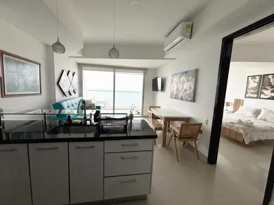 a kitchen with a sink and a bedroom with a bed at APARTAMENTO PALMETTO ELIPTIC Bocagrande in Cartagena de Indias