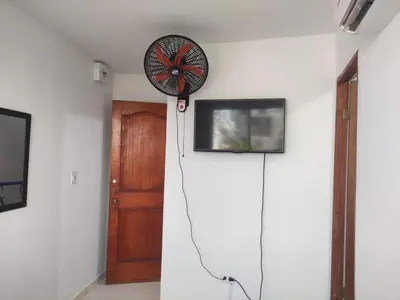 a room with a fan on the wall next to a door at DULCE HOGAR in Cartagena de Indias