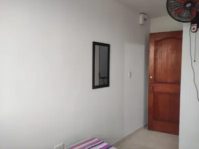 a room with a mirror and a wooden door at DULCE HOGAR in Cartagena de Indias