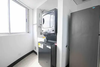 a small room with a tv on top of a refrigerator at Apartamento Bocagrande Vista al Mar Piso 21 in Cartagena de Indias