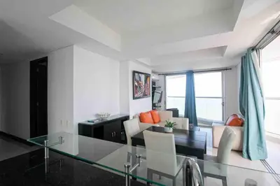 a living room with a glass table and chairs at Apartamento Bocagrande Vista al Mar Piso 31 in Cartagena de Indias