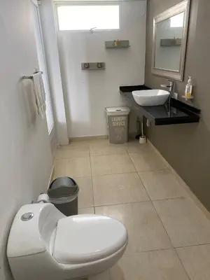a bathroom with a toilet and a sink at Villa frente al Mar cerca a Barranquilla in Tubará