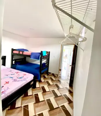 a room with two bunk beds and a floor at Apartamentos Rincón Garcia in Cartagena de Indias