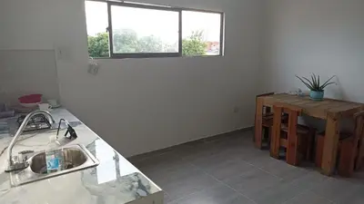 a kitchen with a sink and a table and a window at Apartamento Cómodo y encantador en cartagena in Cartagena de Indias