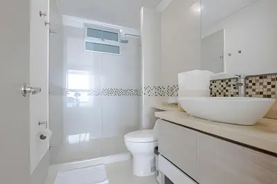 a white bathroom with a sink and a toilet at Laurdhomes Lujoso Apto Piso 28 frente al mar, 2BTH in Cartagena de Indias