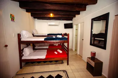 a room with two bunk beds and a mirror at Casa Hotel Marbella Beach in Cartagena de Indias