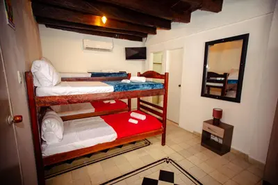 two bunk beds in a room with a mirror at Casa Hotel Marbella Beach in Cartagena de Indias