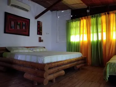 a bedroom with a bed in a room with colorful curtains at Phandy in Santa Veronica