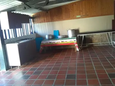 a kitchen with a table in the middle of a room at Phandy in Santa Veronica