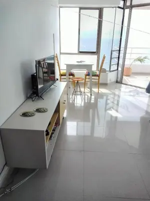a living room with a table and a dining room at Apartamento , vista a la ciudad antigua y playa in Cartagena de Indias