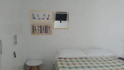 a bedroom with a bed and two pictures on the wall at Apartamento , vista a la ciudad antigua y playa in Cartagena de Indias