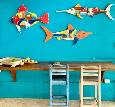 a blue wall with several paper fish on it at Casita Caribe en reserva natural, playa privada, kayaks, wifi, aire acondicionado in San Onofre
