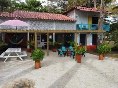 a house with a patio with a table and chairs at Casita Caribe en reserva natural, playa privada, kayaks, wifi, aire acondicionado in San Onofre