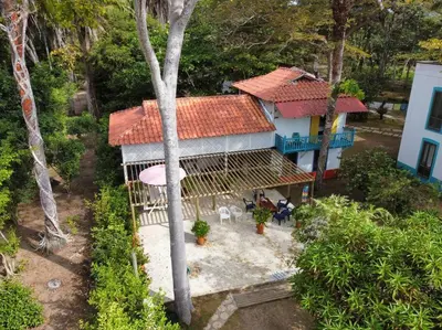 an aerial view of a house with a umbrella at Casita Caribe en reserva natural, playa privada, kayaks, wifi, aire acondicionado in San Onofre