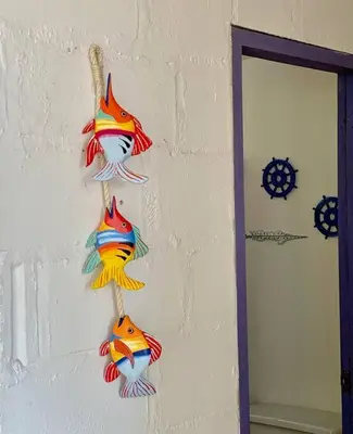 a group of colorful fish hanging on a wall at Casita Caribe en reserva natural, playa privada, kayaks, wifi, aire acondicionado in San Onofre