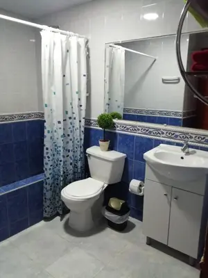 a blue and white bathroom with a toilet and a sink at Acogedor apartamento en Cartagena in Cartagena de Indias