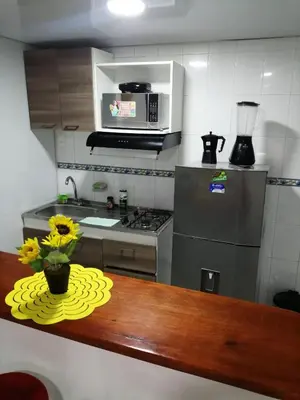 a kitchen with a table with a vase of flowers on it at Acogedor apartamento en Cartagena in Cartagena de Indias
