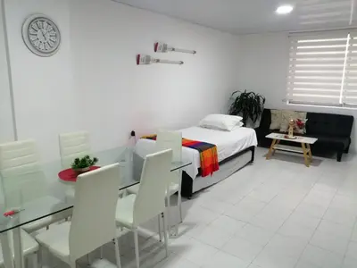 a bedroom with a bed and a table and chairs at Acogedor apartamento en Cartagena in Cartagena de Indias