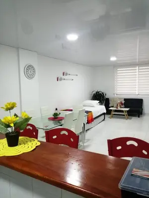 a living room with a table and red chairs at Acogedor apartamento en Cartagena in Cartagena de Indias