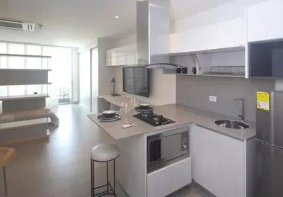 a kitchen with a sink and a stove top oven at Las Margaritas, Loft en Distrito 90 in Barranquilla