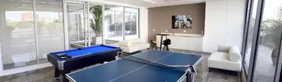 a living room with a blue ping pong table in it at Las Margaritas, Loft en Distrito 90 in Barranquilla