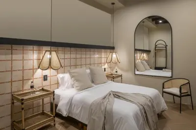 a bedroom with a large white bed and a mirror at Privado Designer Boutique Hotel in Cartagena de Indias