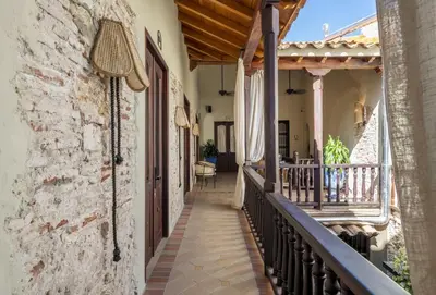 a balcony of a house with a brick wall at Privado Designer Boutique Hotel in Cartagena de Indias