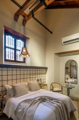 a bedroom with a large bed and a window at Privado Designer Boutique Hotel in Cartagena de Indias