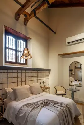 a bedroom with a large bed and a window at Privado Designer Boutique Hotel in Cartagena de Indias