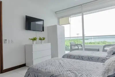 a bedroom with two beds and a tv on a wall at apartamento 1 alcoba morros 922 rnt 132107 in Cartagena de Indias