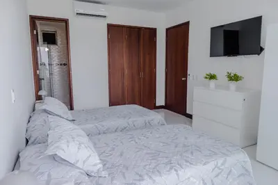 a bedroom with two beds and a flat screen tv at apartamento 1 alcoba morros 922 rnt 132107 in Cartagena de Indias
