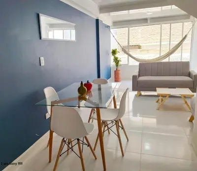 a dining room with a glass table and white chairs at APT cercano centro Histórico N - Marbella O in Cartagena de Indias