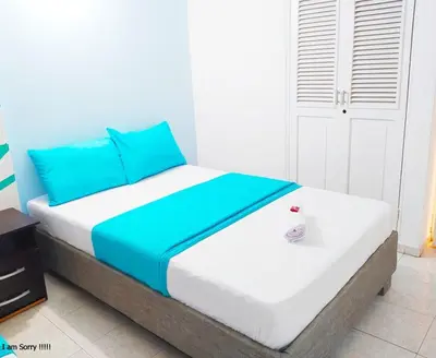 a bedroom with a bed with blue and white at APT cercano centro Histórico N - Marbella O in Cartagena de Indias
