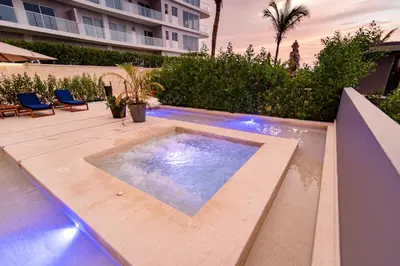 a hot tub on a deck with a building in the background at ✰ Beach Loft ✰ Condominio de lujo ✰ in Cartagena de Indias