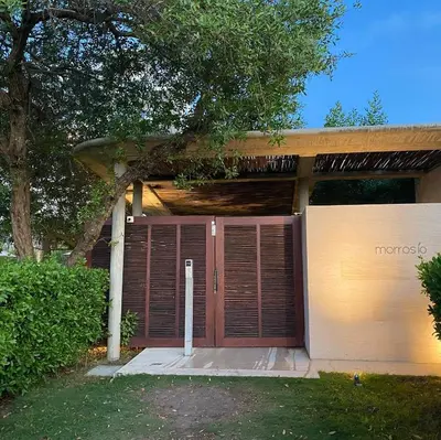 a house with a brown garage door and a tree at ✰ Beach Loft ✰ Condominio de lujo ✰ in Cartagena de Indias
