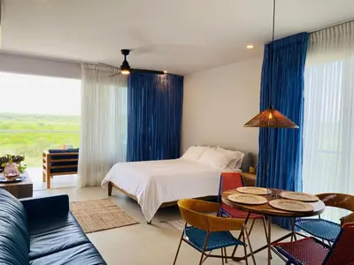 a bedroom with a bed and a table and chairs at ✰ Beach Loft ✰ Condominio de lujo ✰ in Cartagena de Indias