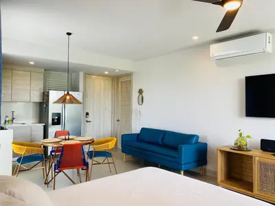 a living room with a blue couch and a table at ✰ Beach Loft ✰ Condominio de lujo ✰ in Cartagena de Indias