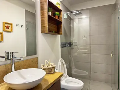 a bathroom with a sink and a toilet and a shower at ¡Amazing Beach Dúplex! Infinity Pool / Rooftop in Cartagena de Indias