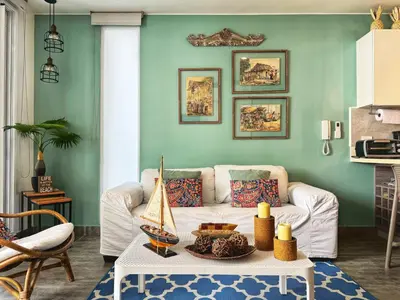 a living room with a white couch and a table at ¡Amazing Beach Dúplex! Infinity Pool / Rooftop in Cartagena de Indias