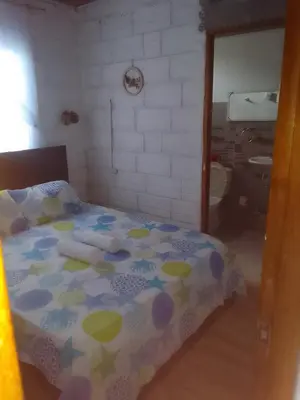 a bedroom with a bed with a polka dot blanket at Apart Cabaña KTIK in San Bernardo del Viento