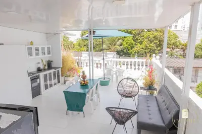 a patio with a table and chairs and an umbrella at Hostal Casa Dandy in Cartagena de Indias