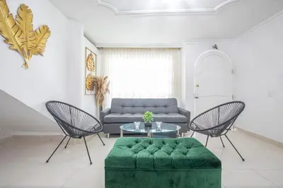 a living room with a couch and a table and chairs at Apartamento en Casa Dandy in Cartagena de Indias